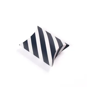 Detail of pillow shaped gift box with classic black and white diagonal stripes design