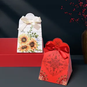 Chinese wedding candy boxes with floral and red designs featuring satin ribbons and bows