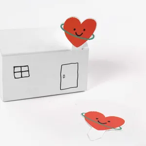 Cute red heart cupcake toppers with smiley face on a white decorative house gift box