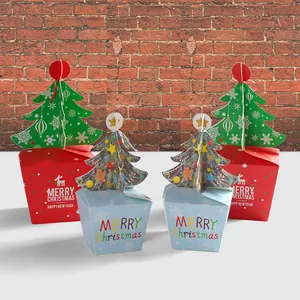 Christmas gift boxes featuring 3D paper trees with festive reindeer and star patterns