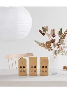 Detail of house-shaped kraft paper gift boxes with cutout windows and rope handle