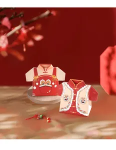 Detail of red Tang suit style candy boxes featuring traditional lion dance and button motifs