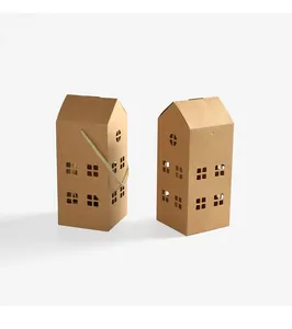 Detail of house-shaped kraft paper gift boxes with cutout windows and white woven handles