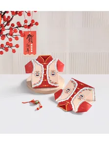 Detailed view of red Tang suit style candy boxes featuring traditional lion dance patterns