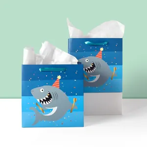 Blue shark party gift bags with silk handles and cute cartoon prints in a 2-piece set
