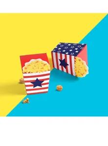 Close-up of popcorn boxes with American flag stars and stripes pattern on blue-yellow background