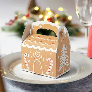 Scatola regalo di Natale a forma di casa di pan di zenzero con manico e fiocchi