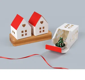 Detailed view of house-shaped gift box with red roof and cutout heart pattern