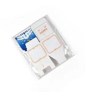 Flat pack view of white candy boxes with orange happy text and blue castle designs