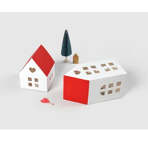 Detail of red and white house-shaped paper gift boxes with heart-shaped cutouts