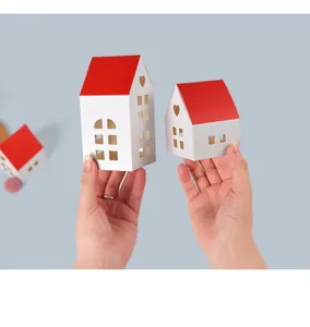 Macro detail of red and white house-shaped paper gift boxes with heart-shaped cutouts