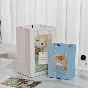 Vertical gift bags with windows showing teddy bear and jewelry box inside