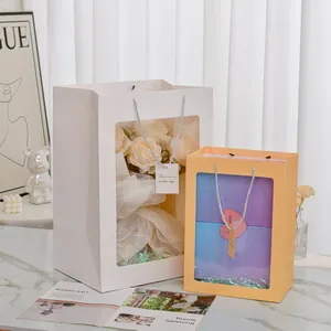 Vertical gift bags with transparent windows, woven handles and decorative gift tags