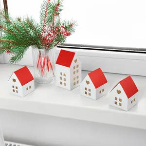 Set of four white paper house gift boxes with red roofs and heart-shaped cutouts for candy
