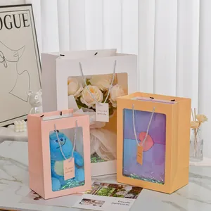 Detailed view of pastel gift bags with clear PVC windows and silver braided handles