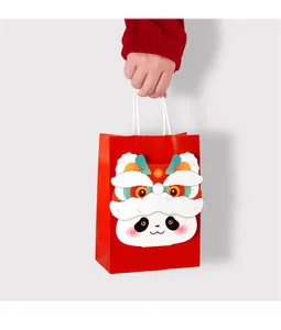 Detail of red festive gift bag featuring 3D panda lion dance motif and white rope handles