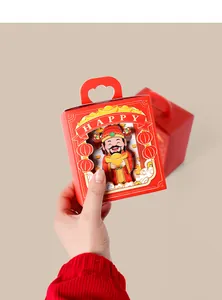 Detail of red festive candy box with God of Wealth cartoon and heart handle