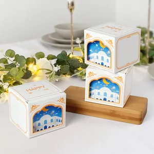White 3D square gift box with Eid theme window and Happy text on wooden surface