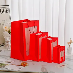 Red paper gift bags with PVC window and rope handle in four assorted sizes