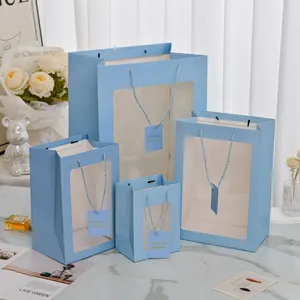 Set of 4 light blue gift bags with transparent windows and 'Tomorrow' tags for gifting