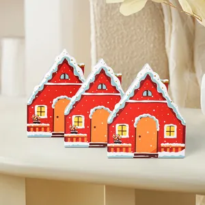 Three red wooden Christmas house tabletop decorations with snow roof and festive design