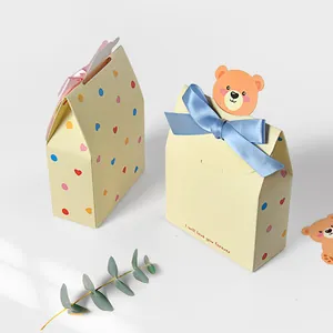 Cartoon chocolate gift boxes with cute bear cards and colorful ribbon bows in light yellow