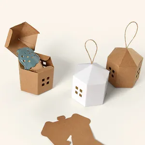 Minimalist house-shaped gift boxes in white and kraft paper with hollow windows and twine