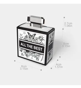 Detail view of perfume bottle shape gift box with black and white floral prints