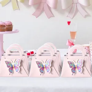 Pink DIY butterfly gift boxes for wedding candy favors in a festive party setting