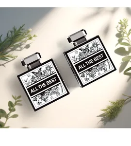 Top view of two perfume bottles with floral labels and All The Best text in black boxes