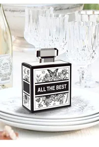 Detail of perfume bottle-shaped gift box with black and white floral prints and text