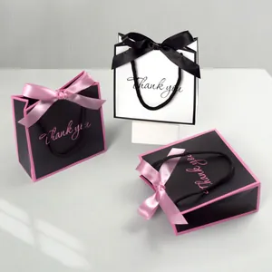 Minimalist black and white gift bags with silk bow and Thank You text for parties