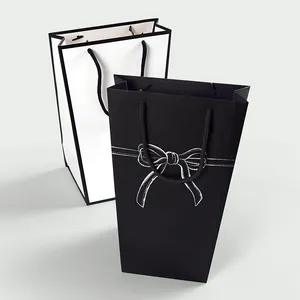 Minimalist black and white trapezoid gift bags with bow design and rope handles