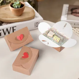 Creative envelope gift boxes with red heart stickers and raffia for Valentine's Day favors