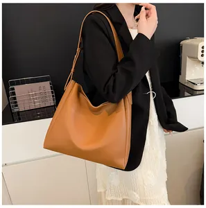 Detail shot of camel leather tote bag with long shoulder straps for office commute