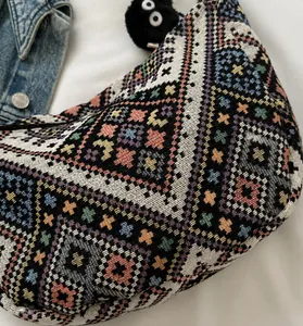 Detailed view of ethnic jacquard woven dumpling bag with colorful geometric patterns