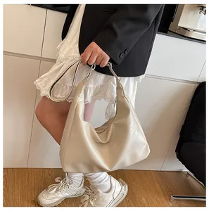 Fashionable large capacity beige tote bag shown on shoulder with soft leather texture