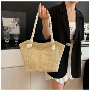 Detailed close-up of straw woven tote bag featuring natural texture and thick cotton rope handle