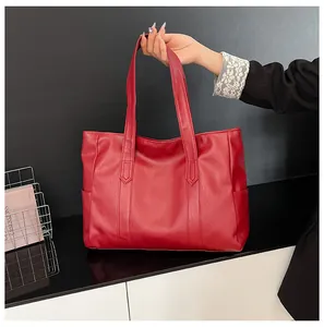 Macro view of large red tote bag with tree bark texture and reinforced handles