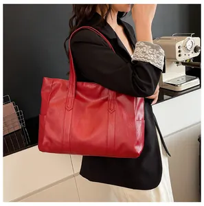 Macro detail of red large-capacity tote bag with bark grain leather texture and stitching