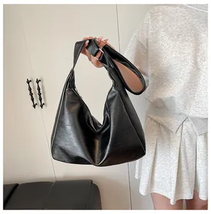 Close-up of a black crescent hobo bag featuring premium leather texture and chain detail