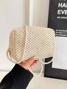 Minimalist beige hand-woven crossbody bag with a rectangular hollow texture and slim strap