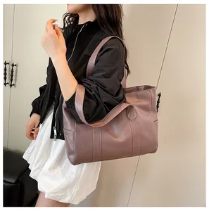 Detailed view of dusty rose tote bag with elegant bark texture and wide shoulder straps