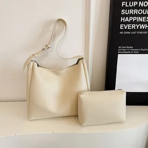 Creamy leather hobo tote and pouch set with adjustable strap in a minimalist style