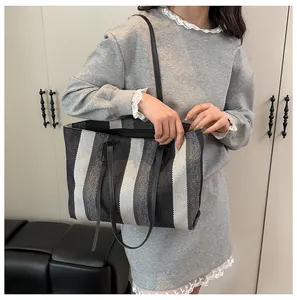 Close-up of textured vertical striped tote bag showing durable canvas material details