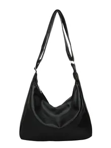 Minimalist black pebbled leather hobo bag with adjustable strap and silver metal hardware