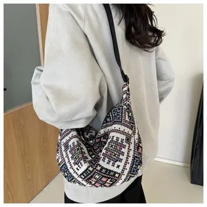 Ethnic style knitted crossbody bag with colorful patterns and adjustable black strap