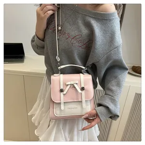 Détails du sac bicolore rose et crème en cuir PU avec nœud décoratif et poignée supérieure