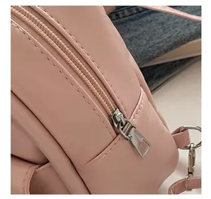 Detail shot of smooth pink nylon fabric with high-quality metal zipper and puller