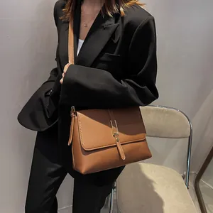Caramel brown vintage leather crossbody bag for women in a professional minimalist style